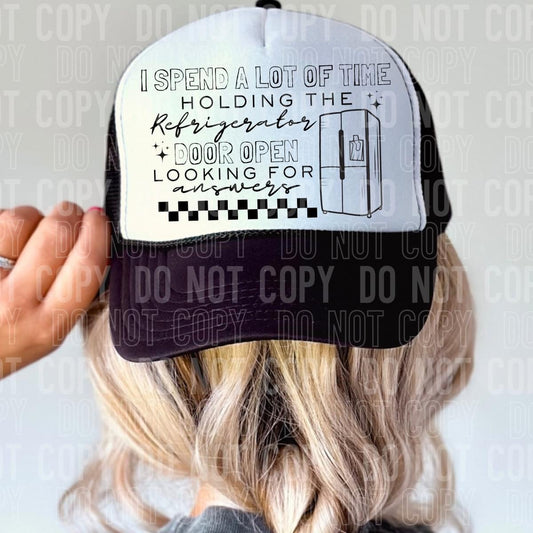 I spend a lot of time holding the refrigerator door open looking for answers Trucker Hat